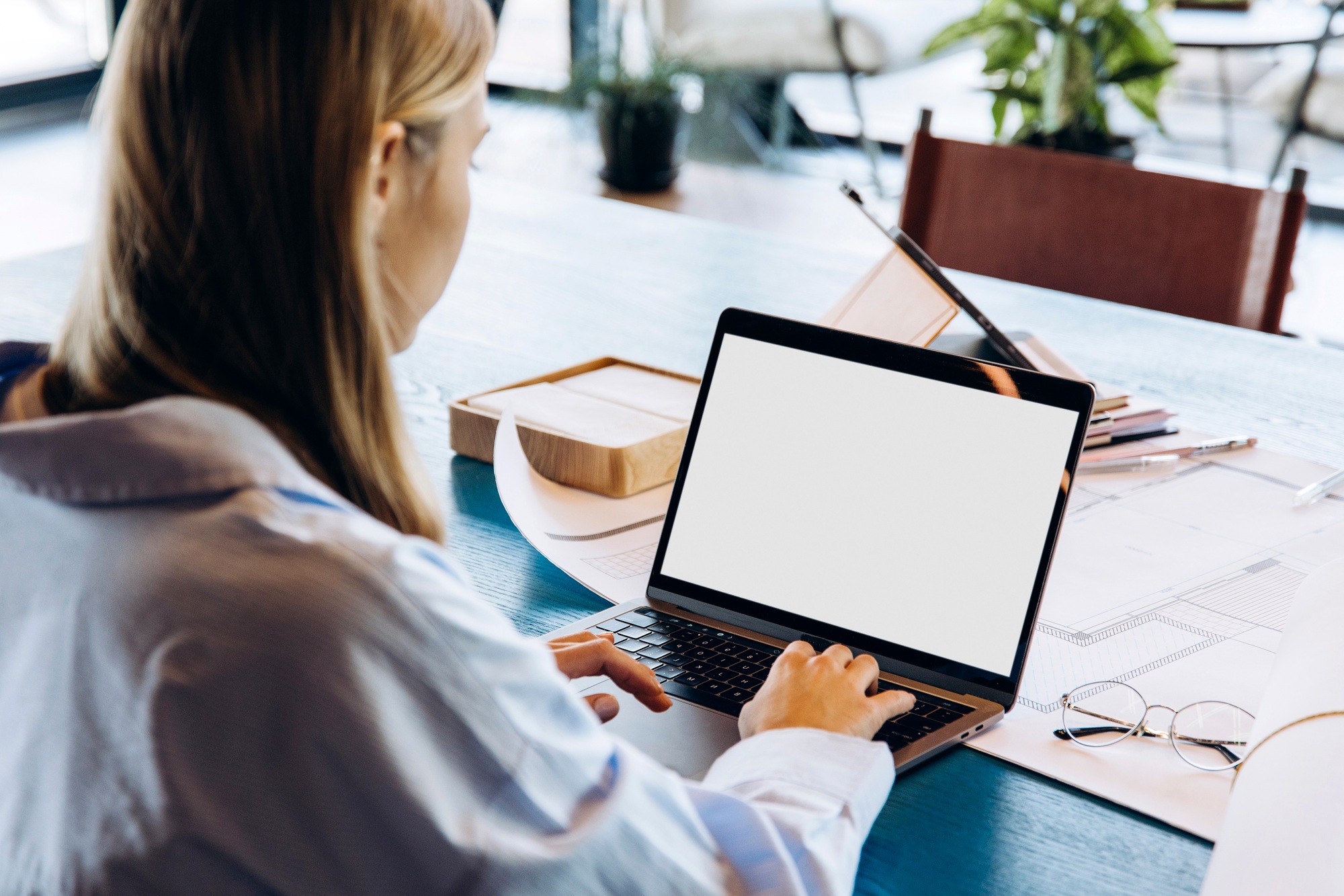 Architect working on laptop with blank screen in office